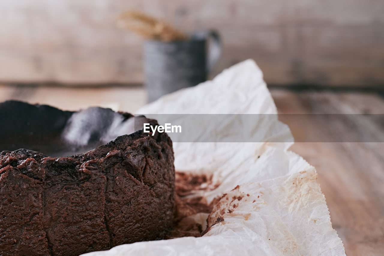 Chocolate basque cheesecake on a wooden table ready to serve