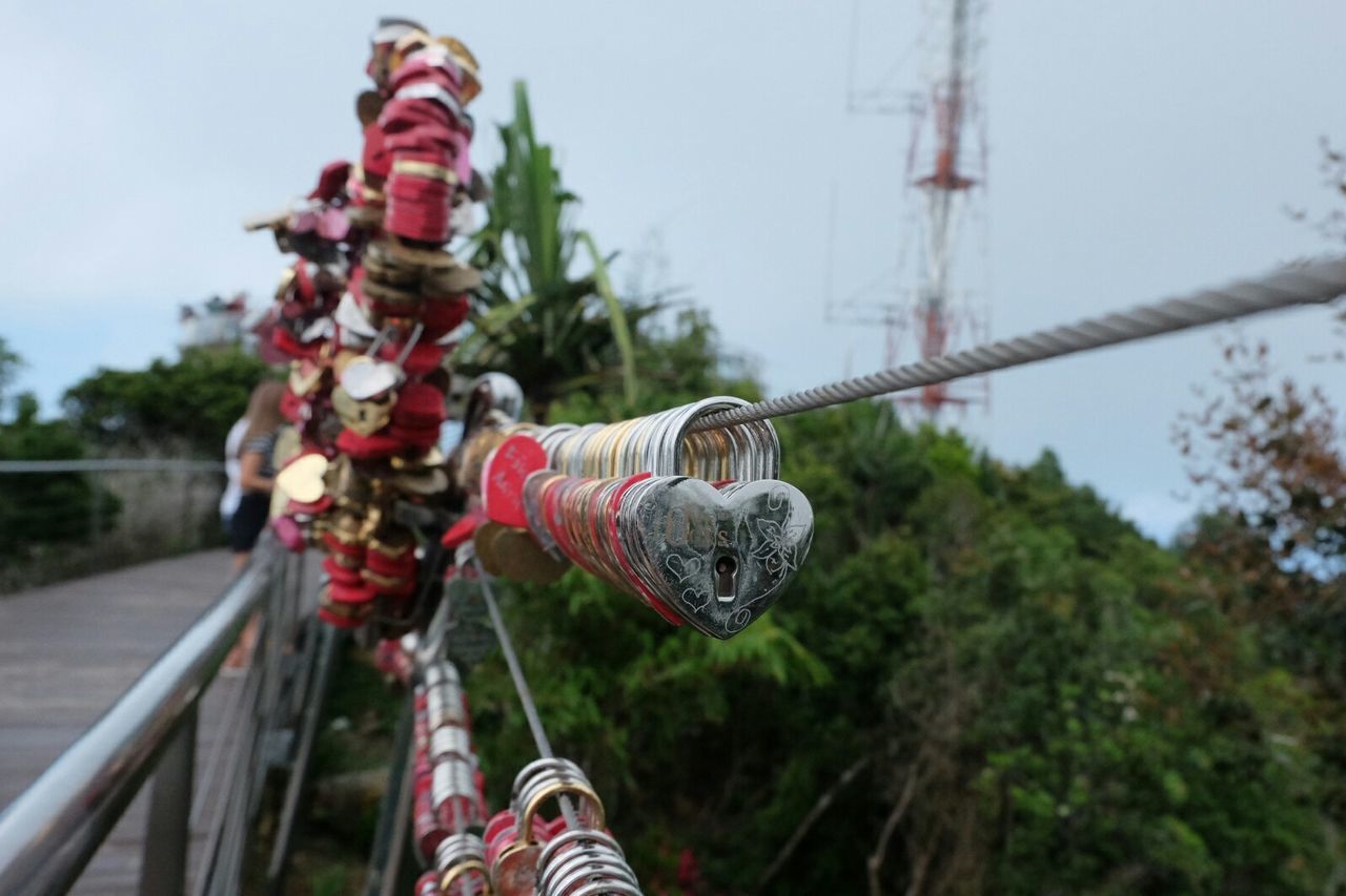 Love locks hanging on railing of langkawi sky bridge