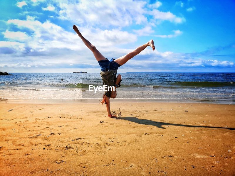 Full Length Of Girl Doing Handstand On Id 131189258
