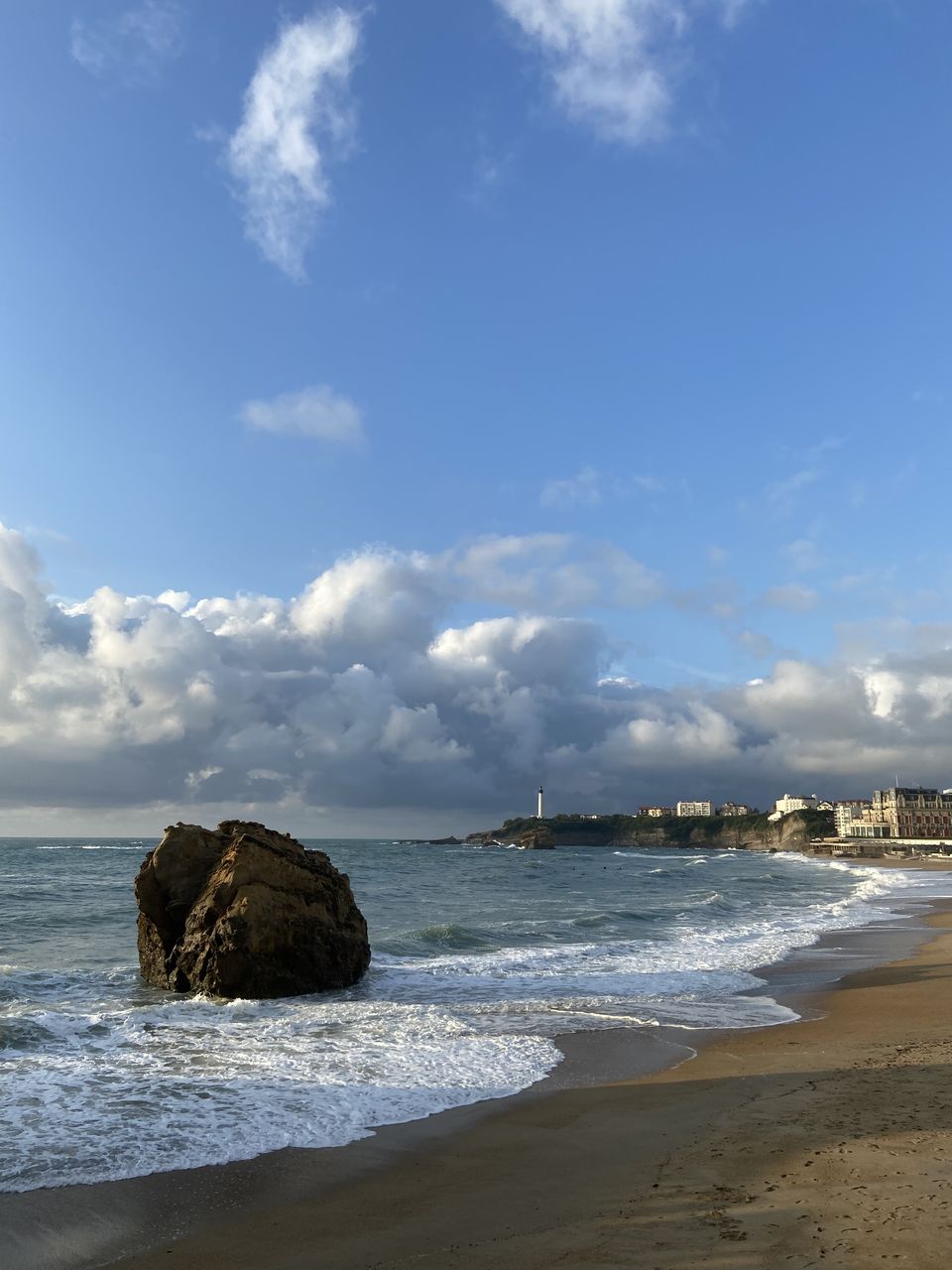 ROCKS ON BEACH AGAINST SKY