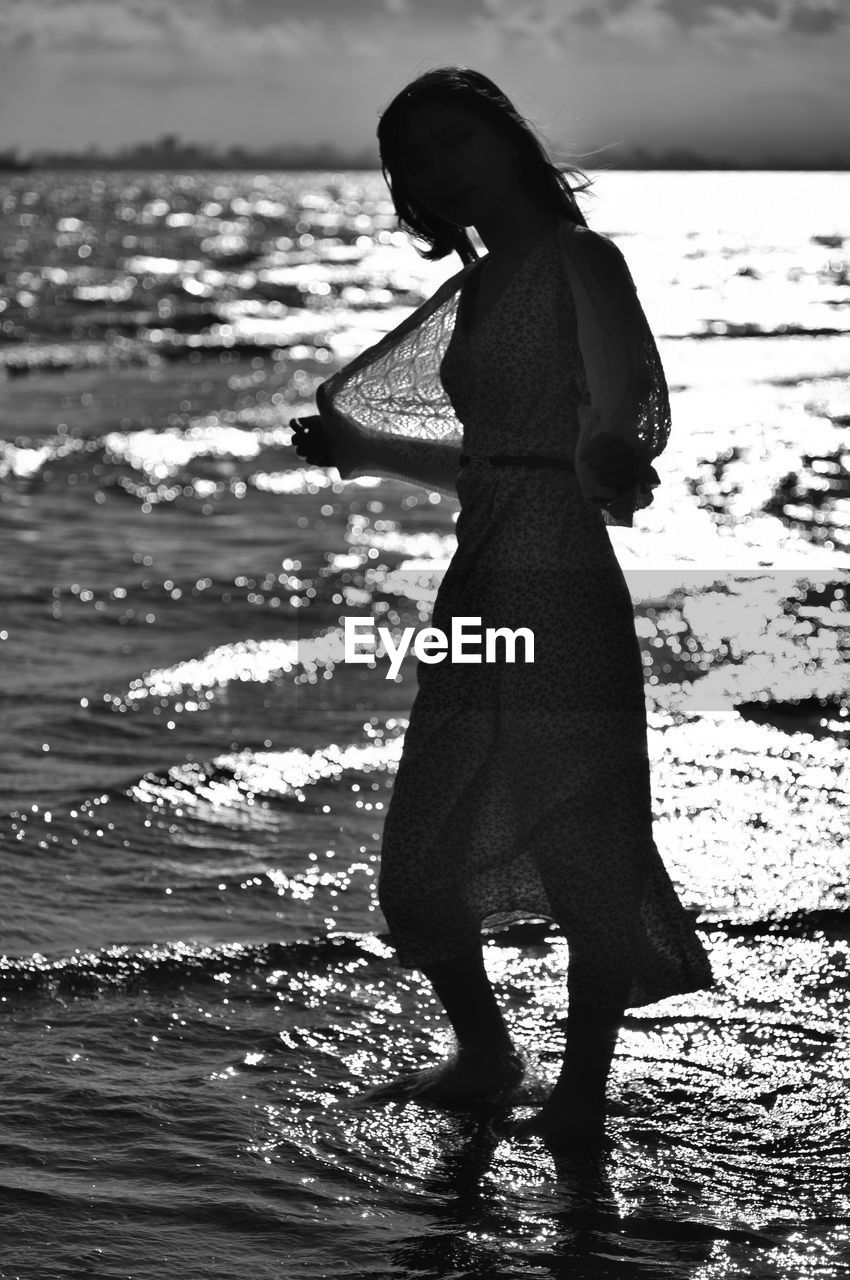 Side view of woman standing on beach
