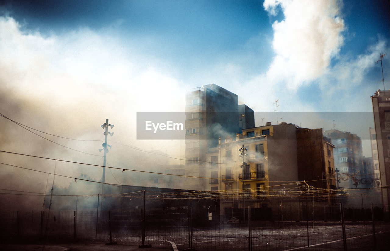 Burnt building in city against sky