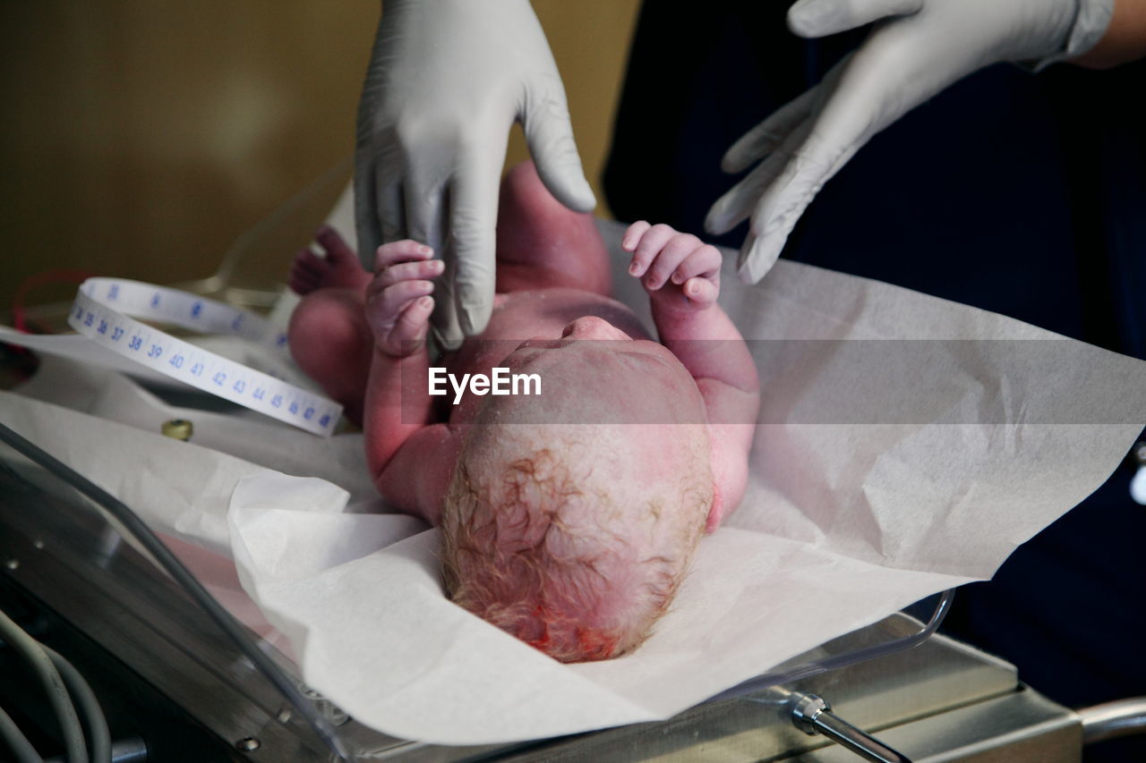 Newborn being weighed
