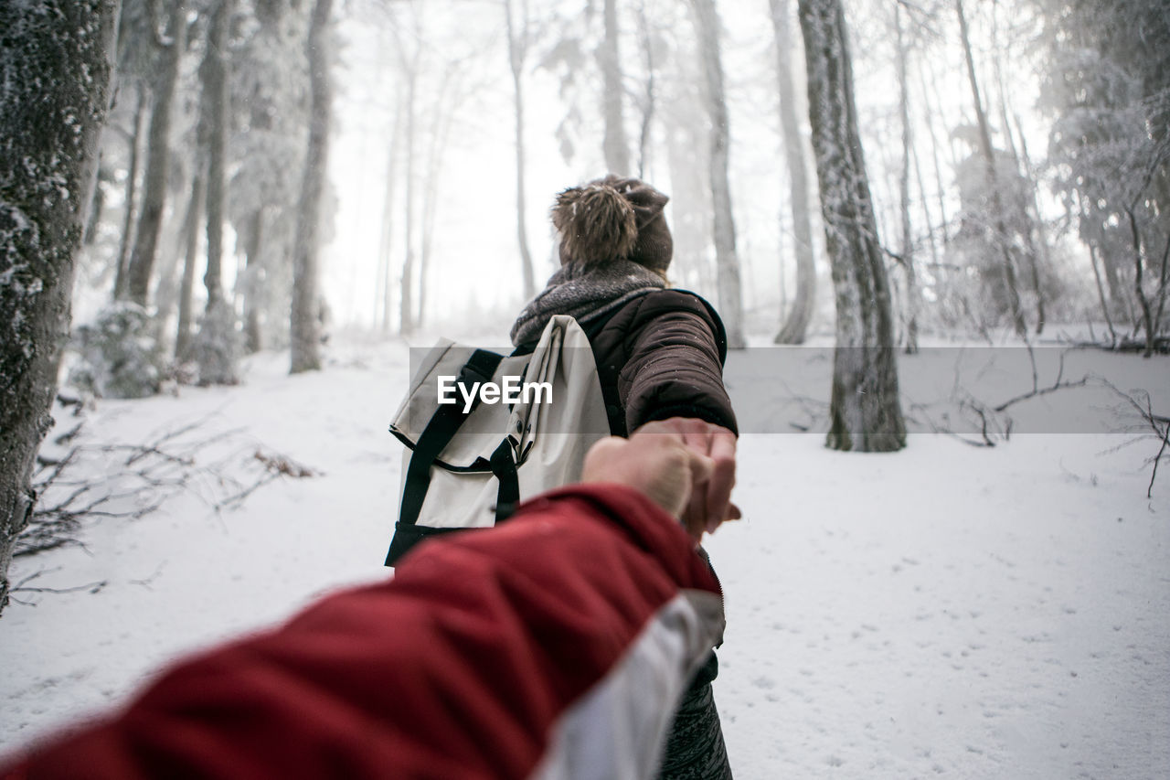 Couple in snow covered forest