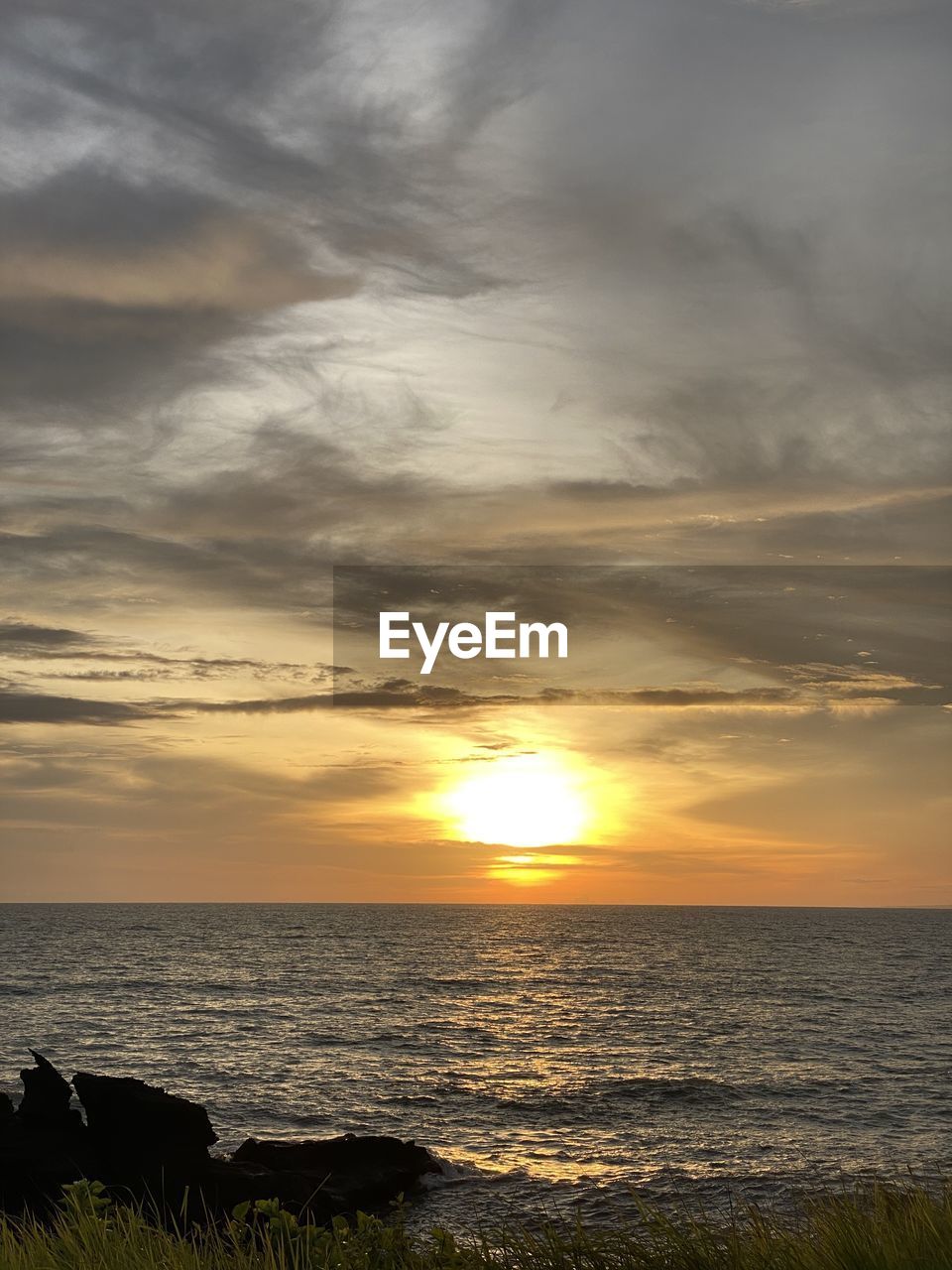 scenic view of beach against sky during sunset