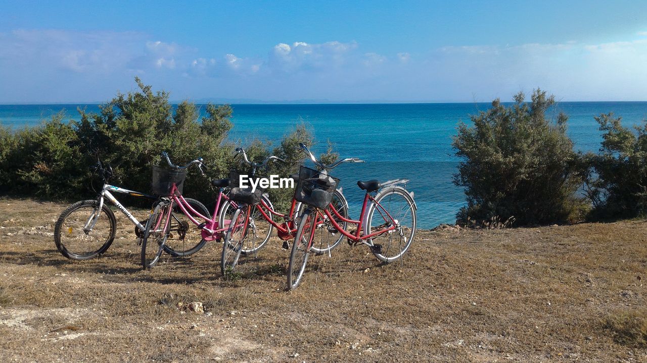 Bicycles parked against sea at beach