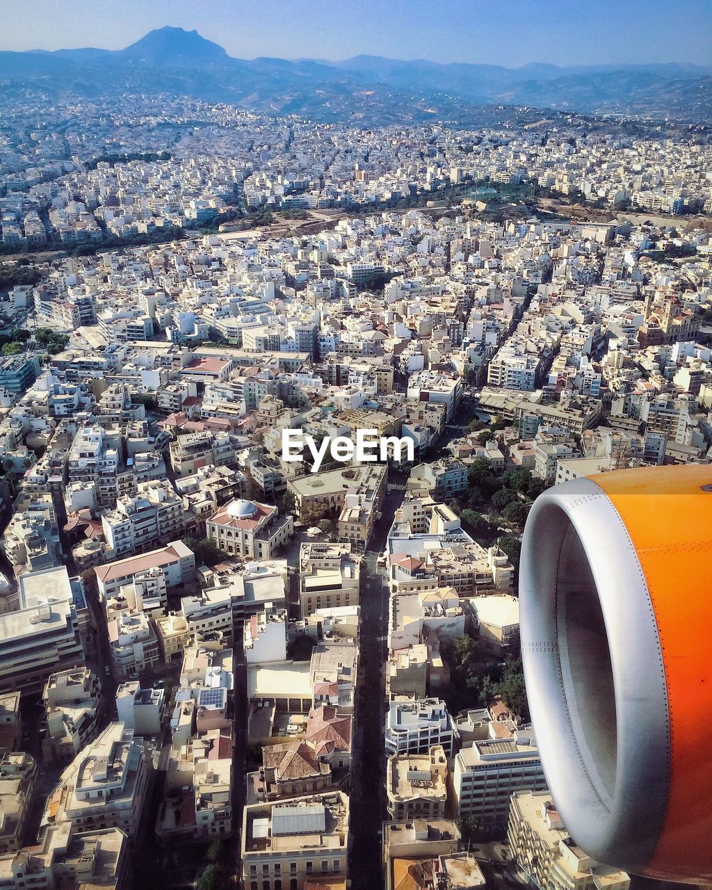 Cropped image of airplane over cityscape