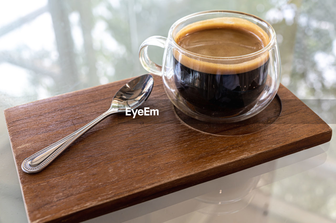 high angle view of coffee in glass on table