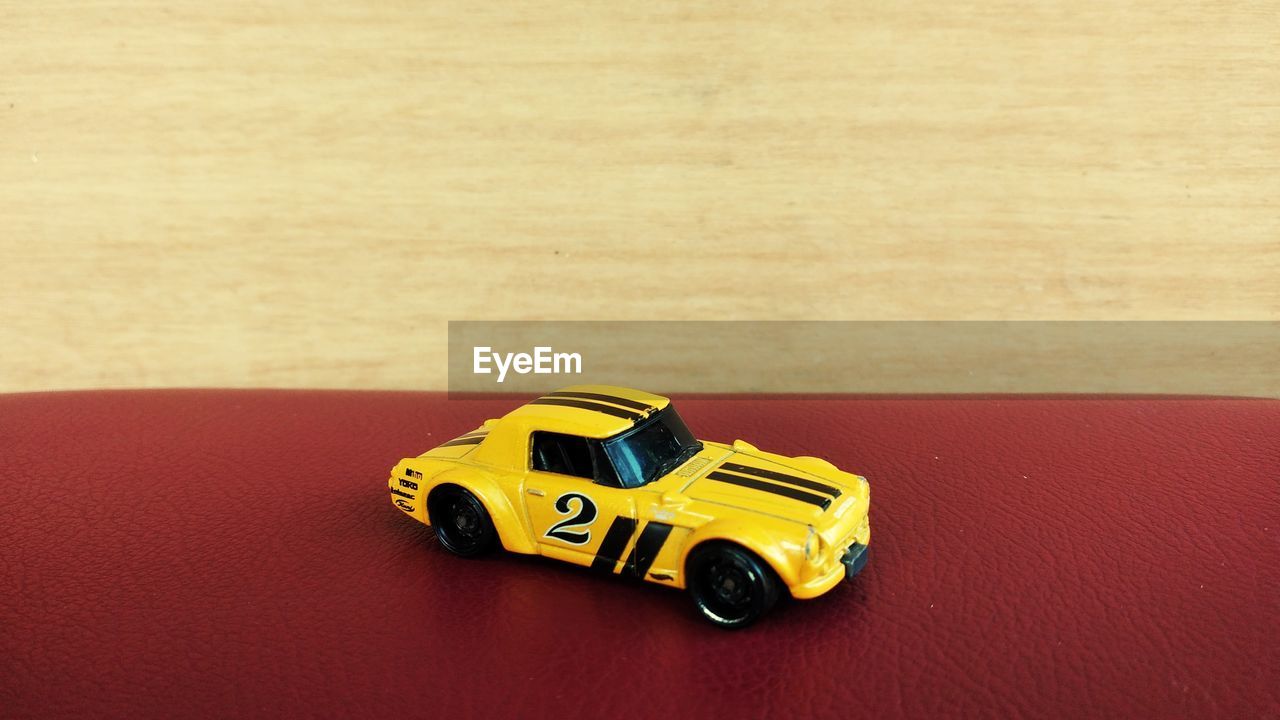 CLOSE-UP OF A TOY CAR ON TABLE