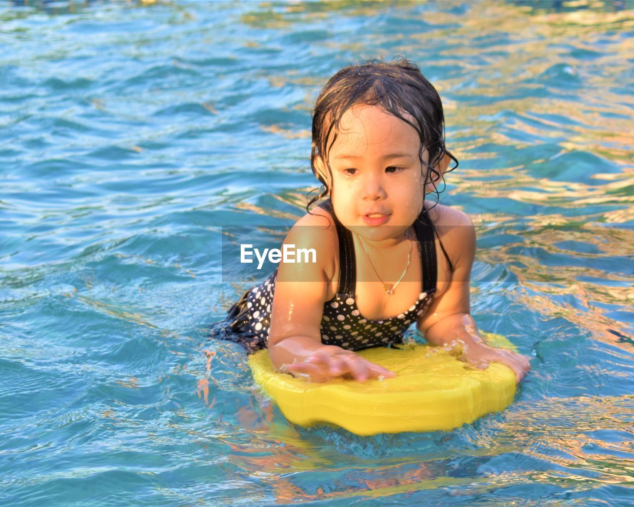 HIGH ANGLE VIEW OF GIRL SWIMMING POOL IN WATER