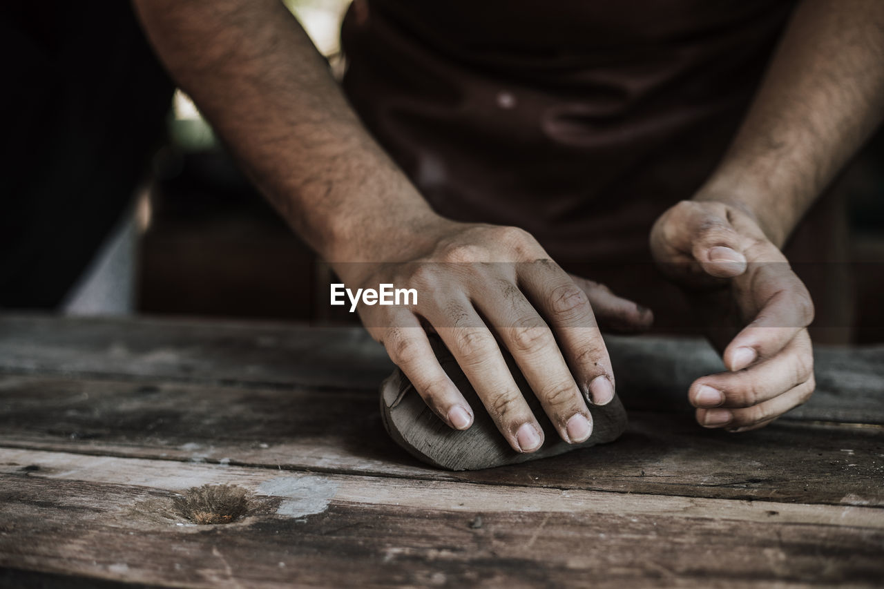 Close-up of artist making pot at workshop