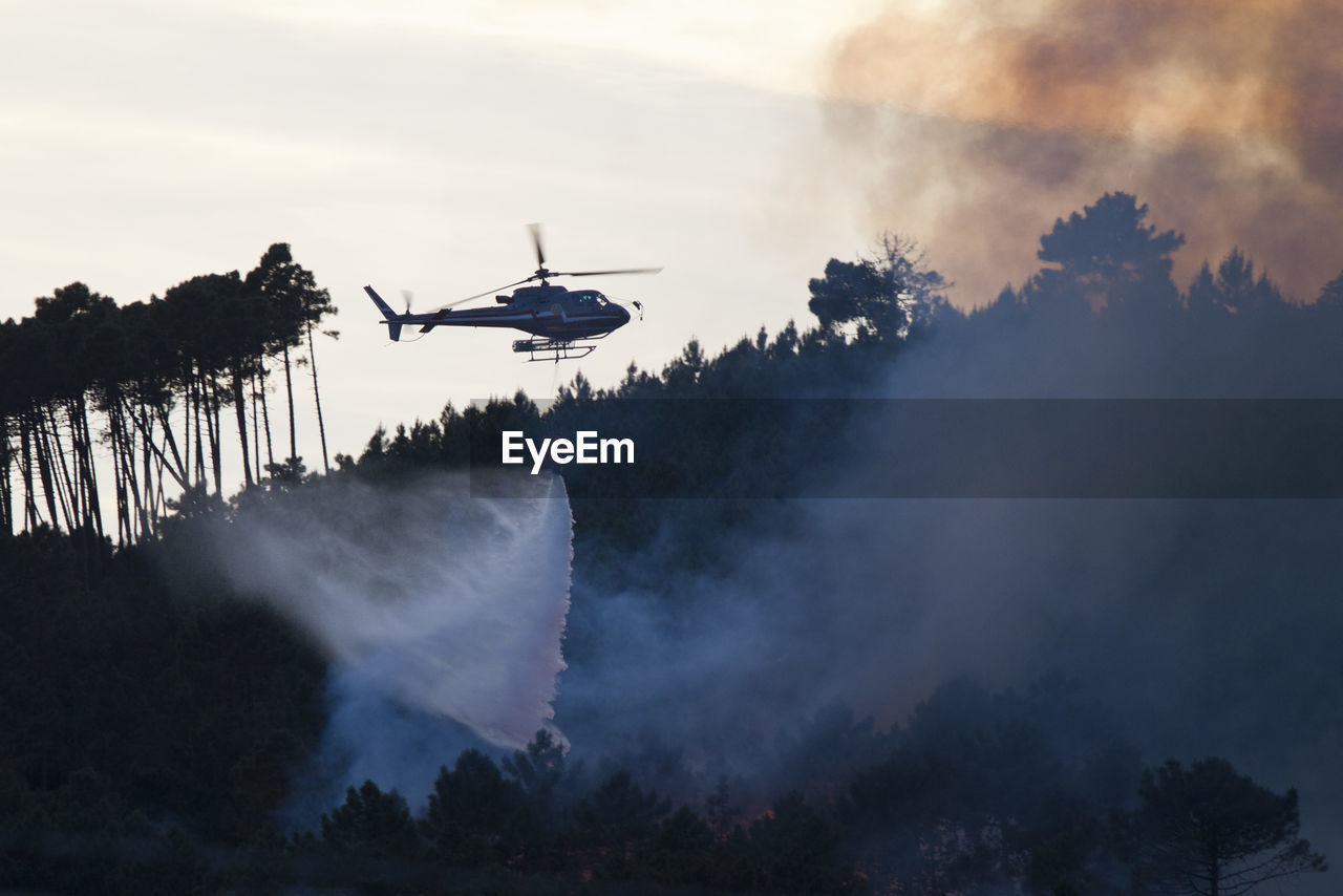 Helicopter flying over forest fire