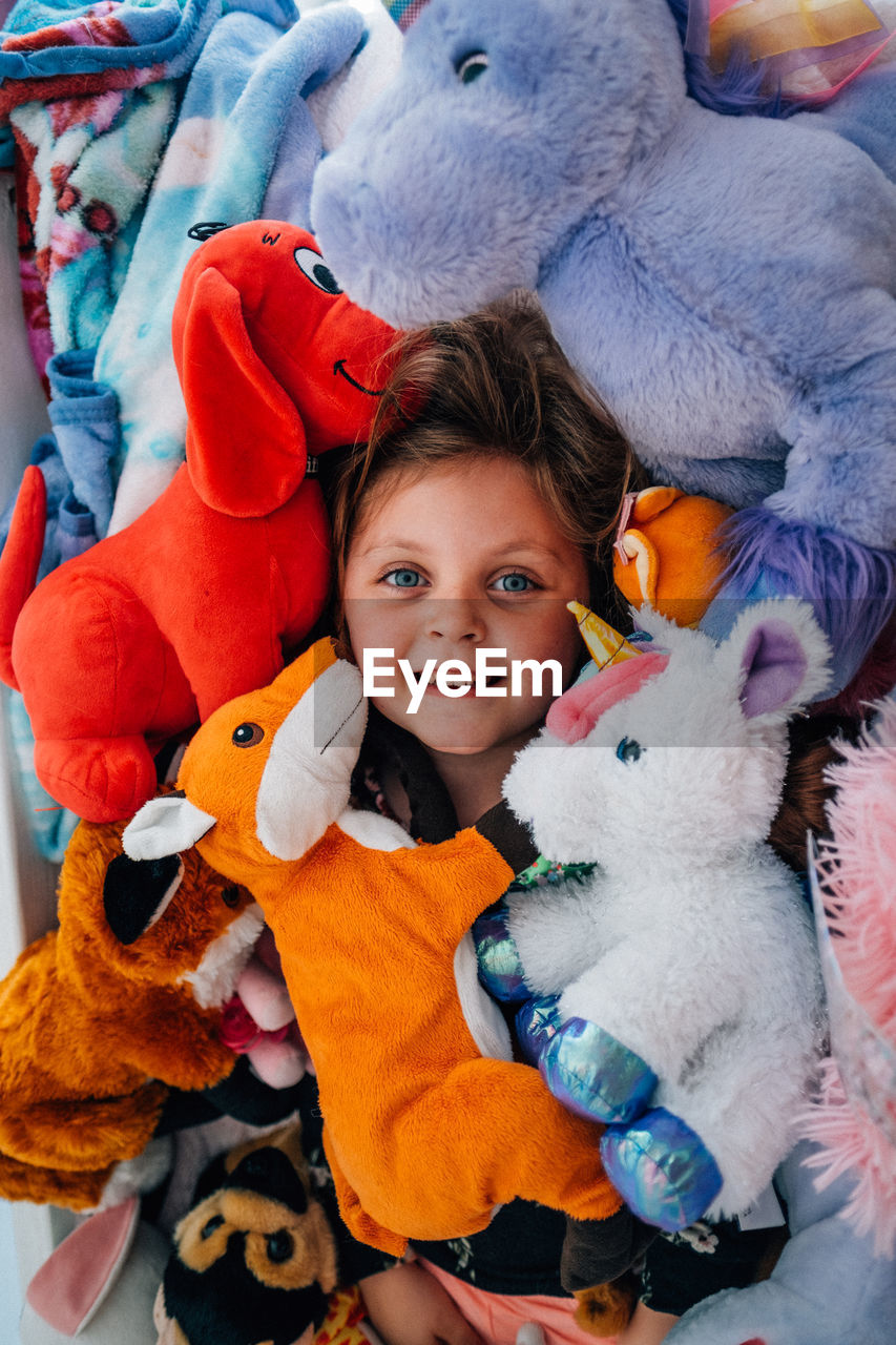 Portrait of cute girl amidst stuffed toys
