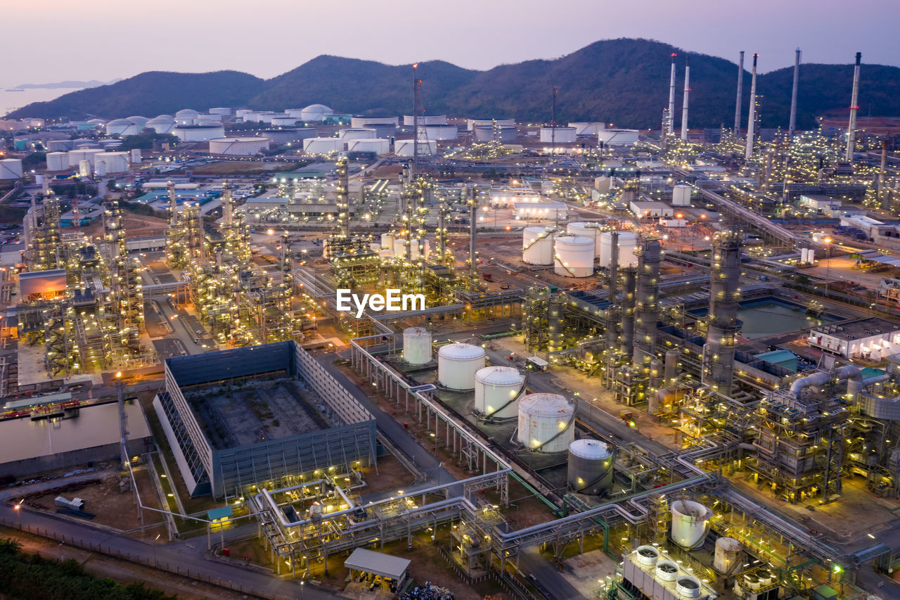 Oil refinery and gas petrochemical industry with storage tanks steel pipeline area at twilight 