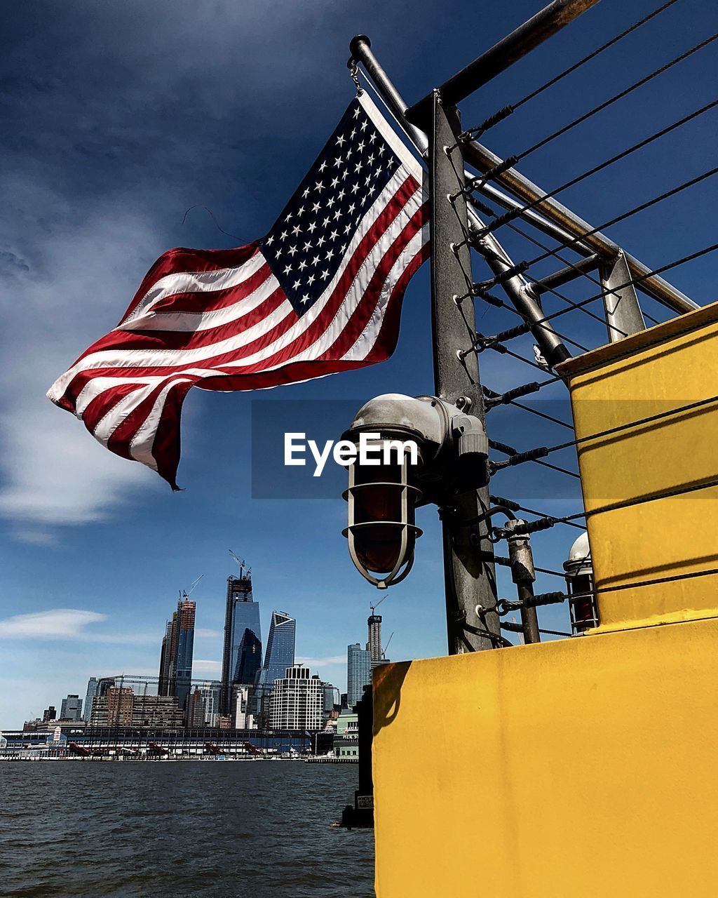 LOW ANGLE VIEW OF FLAGS AGAINST BUILDINGS IN CITY
