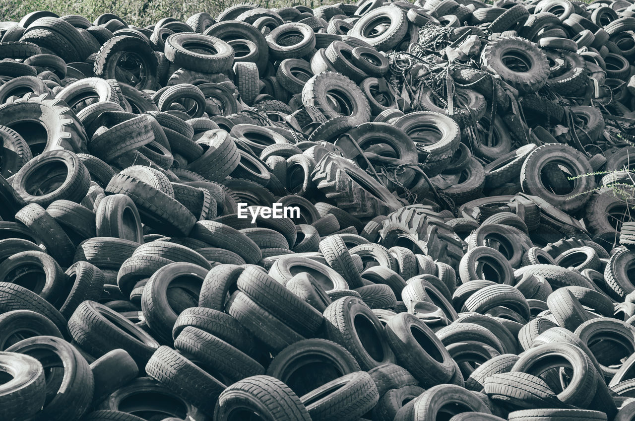Landfill of old car tires torn spoiled abandoned.