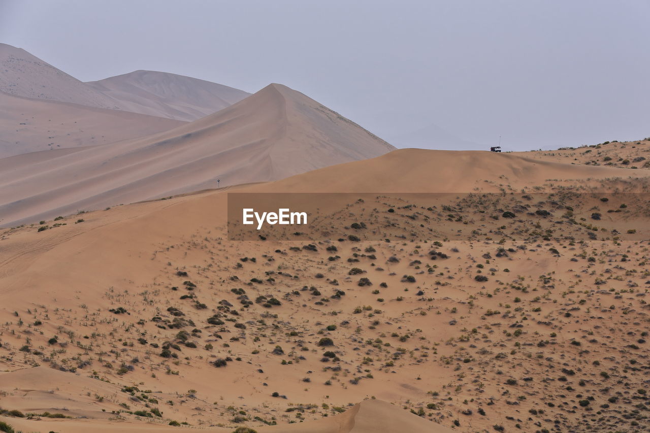 1030 moving and stationary sand dunes-badain jaran desert -tire tracks on the sand. nei mongol-china
