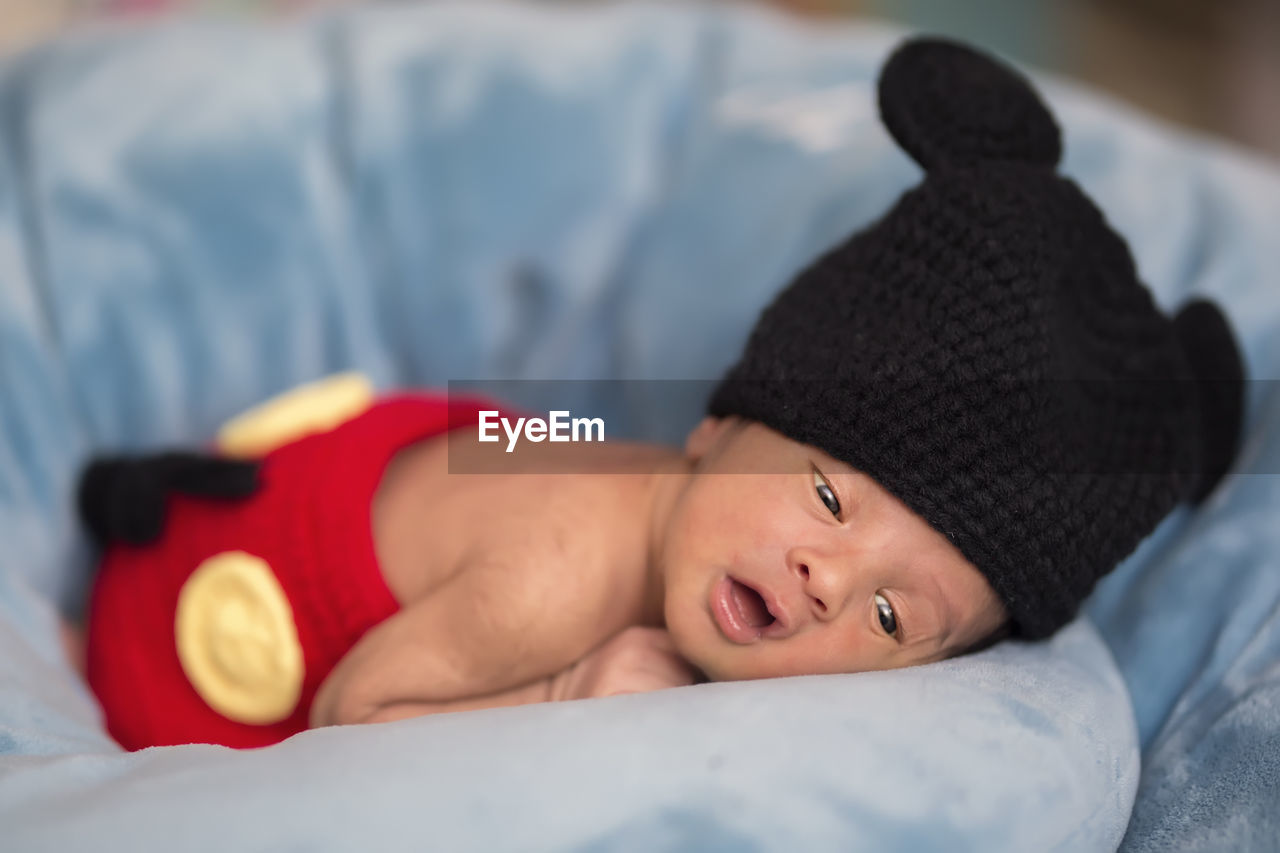 Close-up of newborn baby in mickey mouse costume