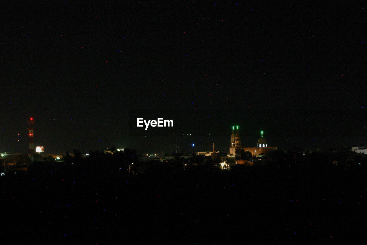 ILLUMINATED CITYSCAPE AT NIGHT