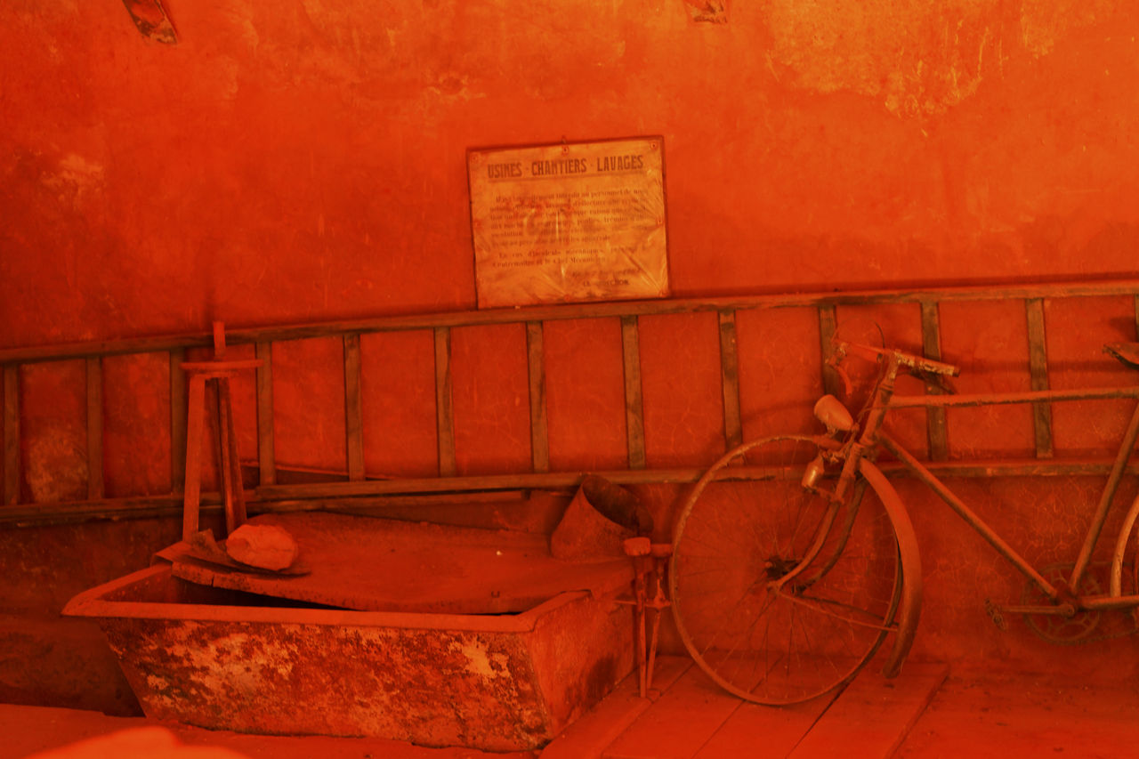 OLD RUSTY BICYCLE BY WALL