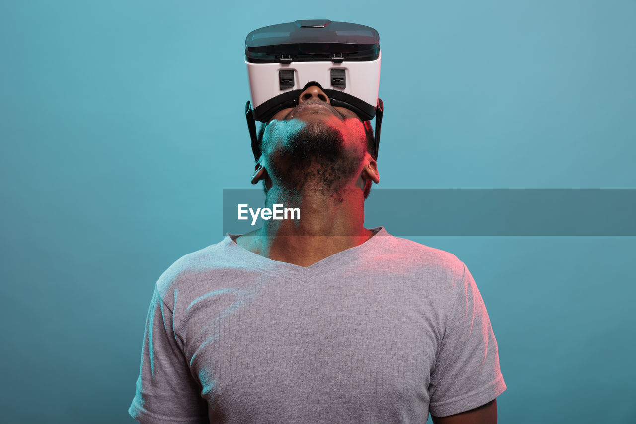 Man looking up while wearing virtual reality headset