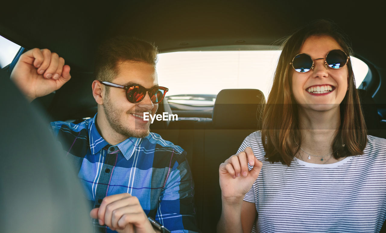 Young couple driving car