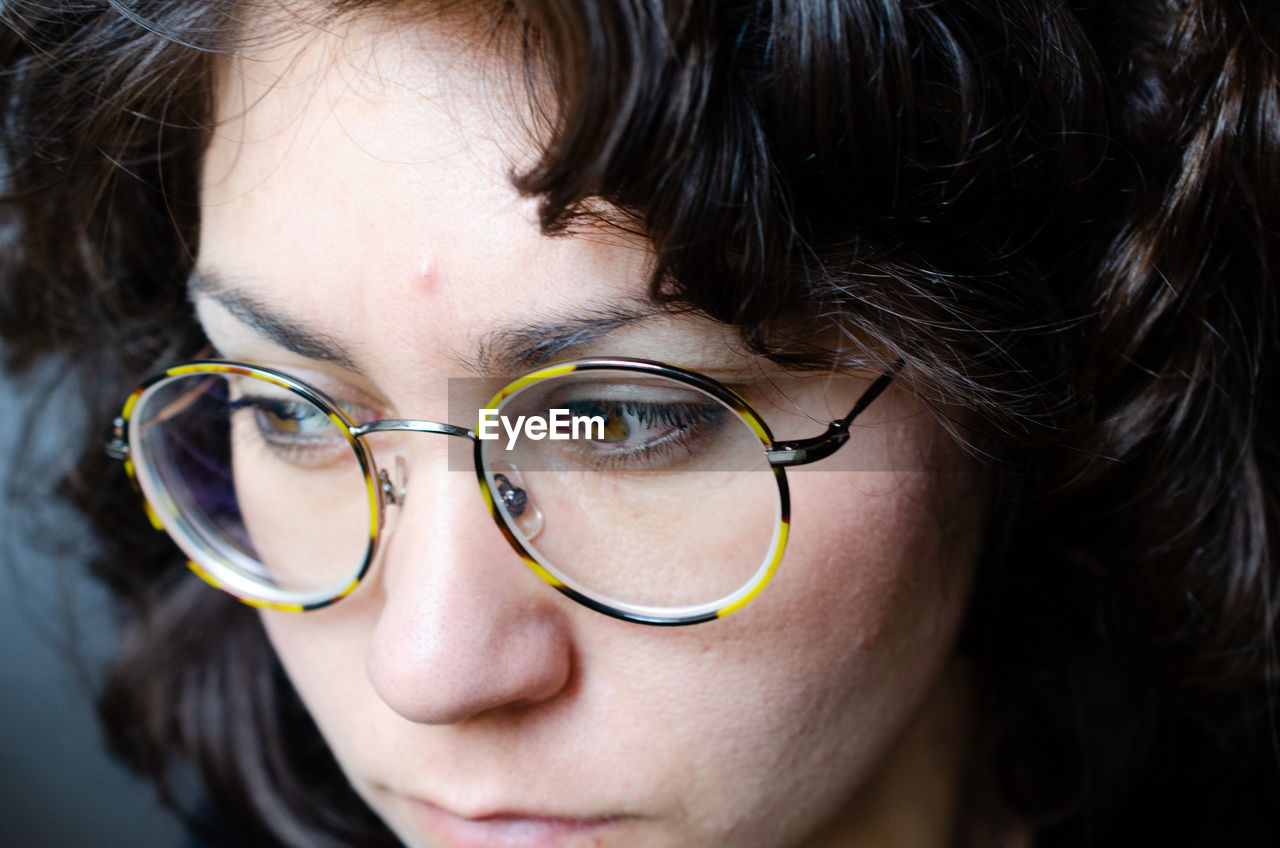 Close-up of thoughtful woman wearing eyeglasses