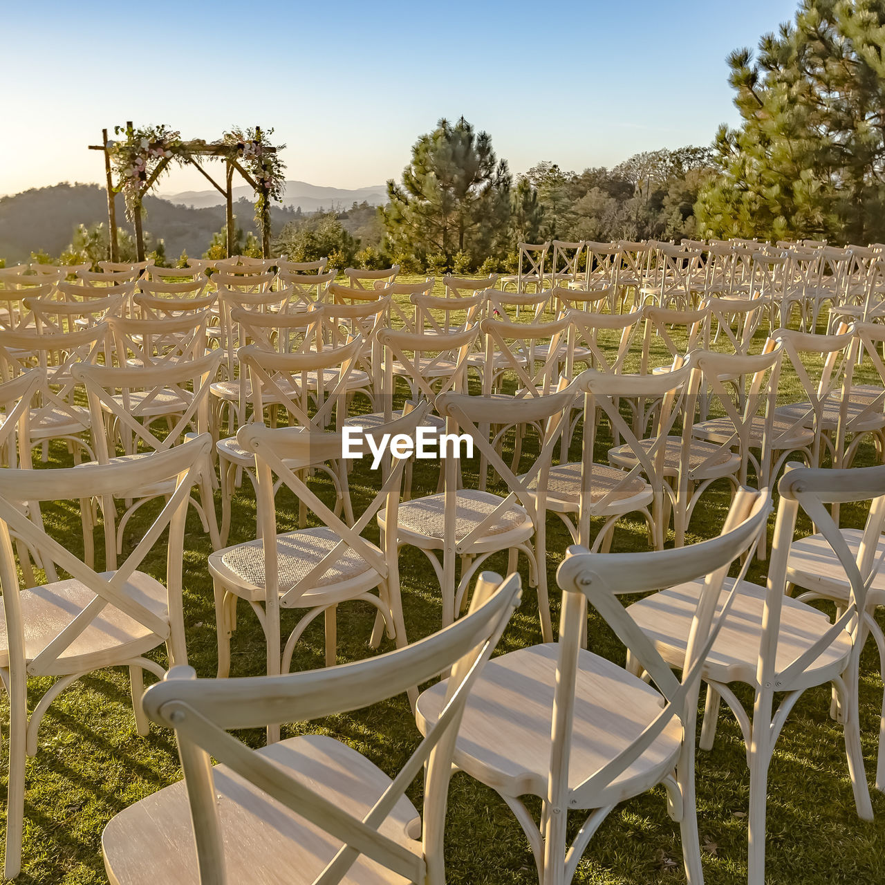 EMPTY CHAIR ON FIELD AGAINST SKY