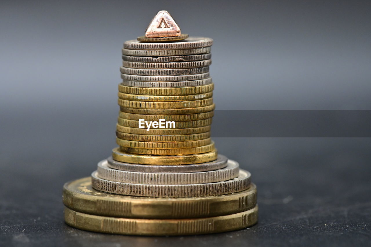 Close-up of coin stack on table
