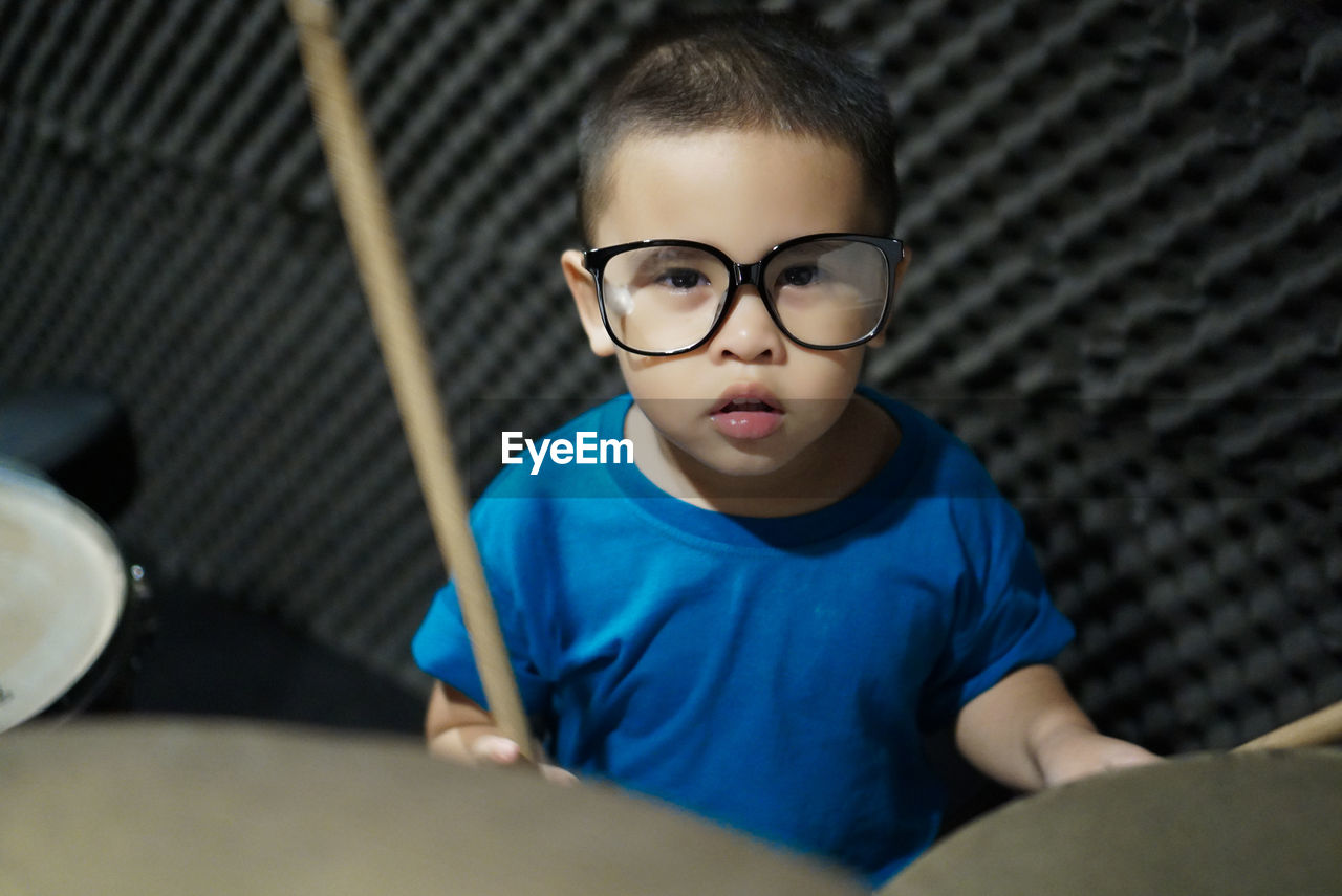 Portrait of boy playing drums