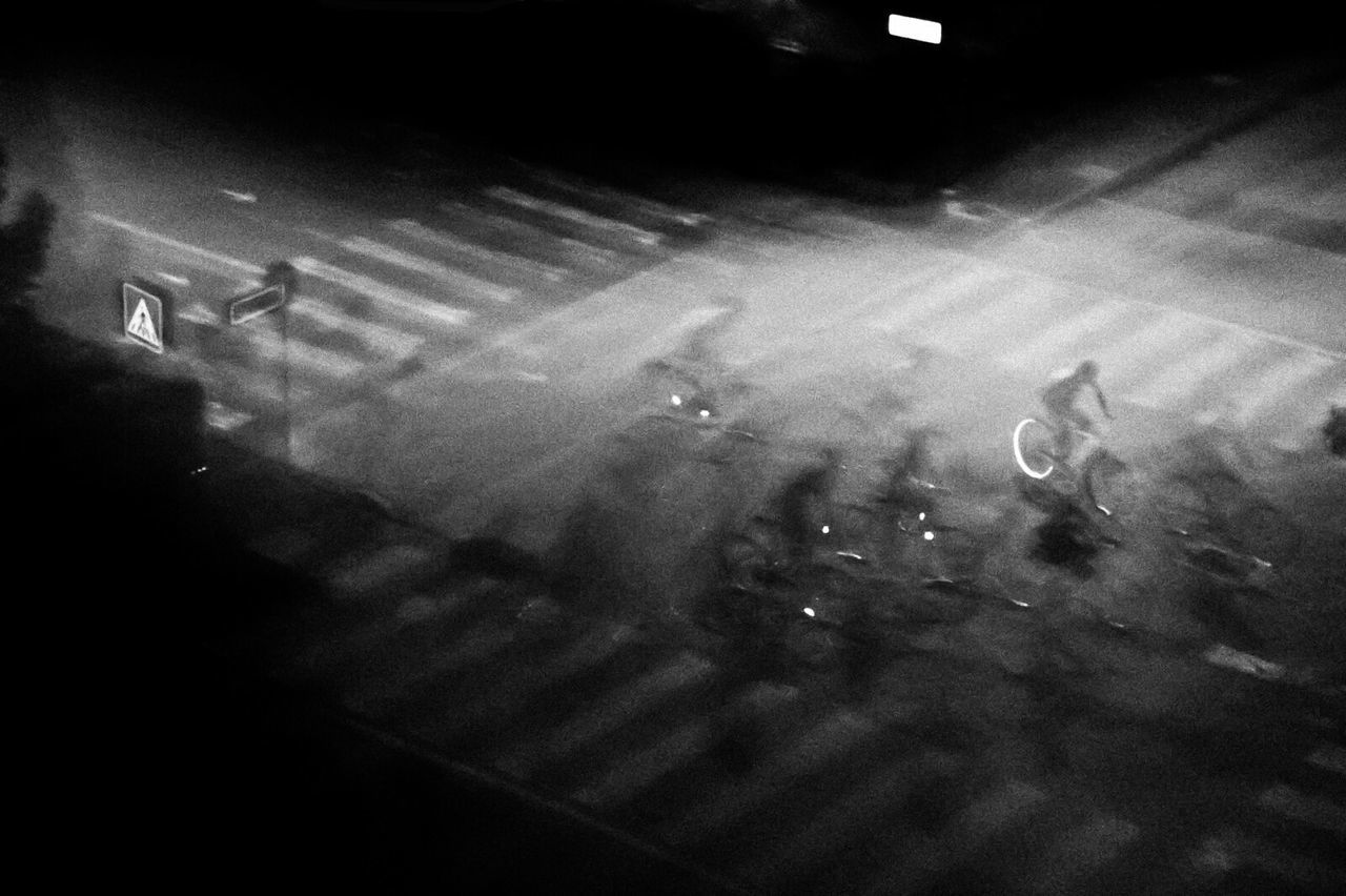 Multiple exposure of man riding bicycle on street