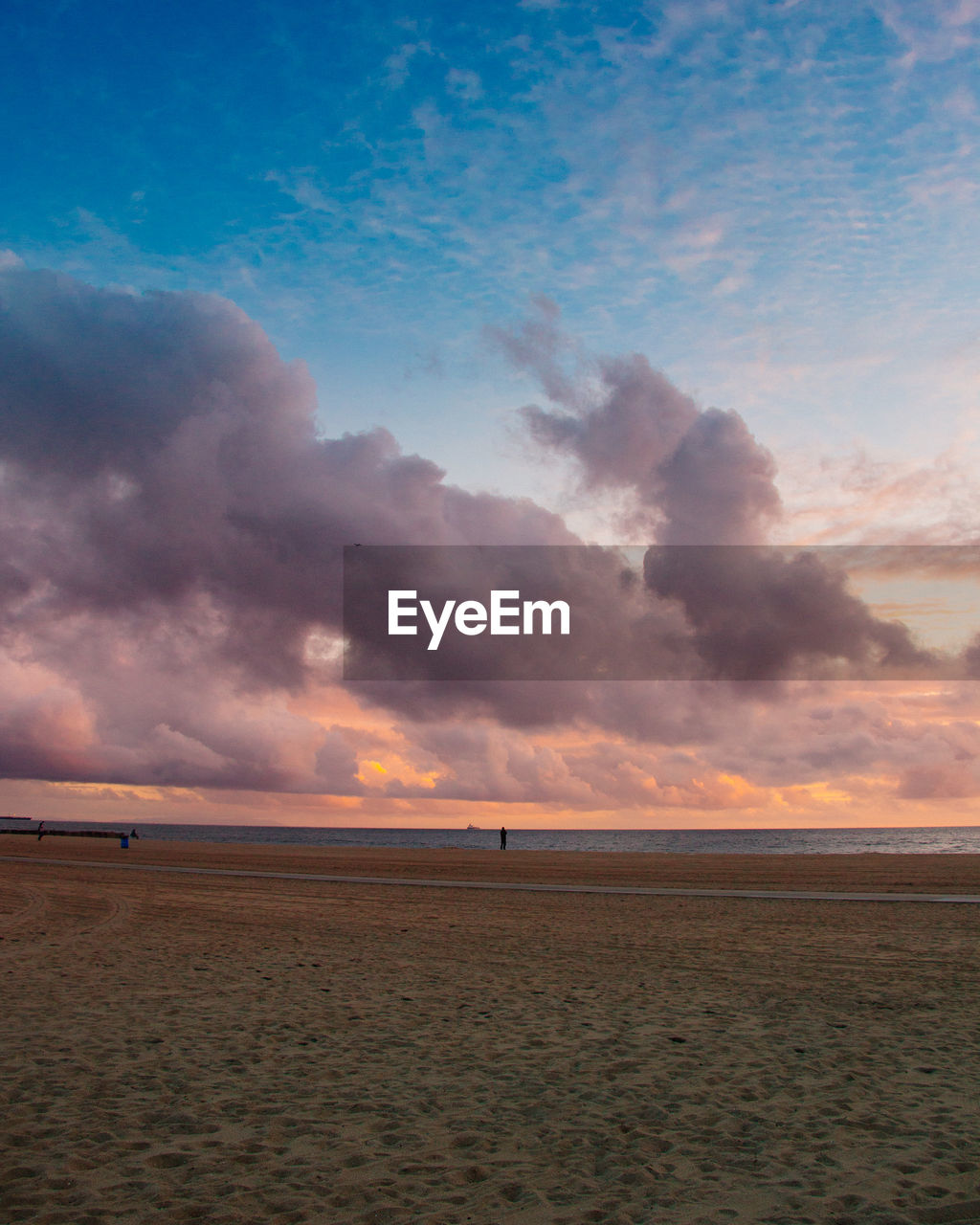 SCENIC VIEW OF BEACH AGAINST SKY AT SUNSET