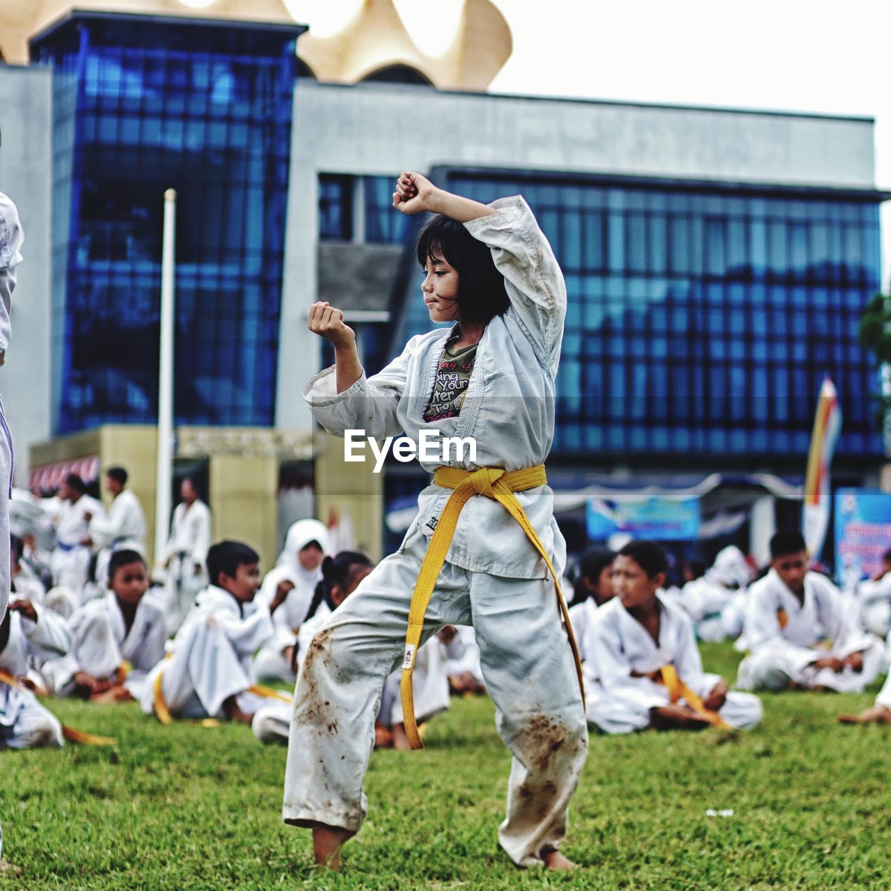 Girl practicing karate on field