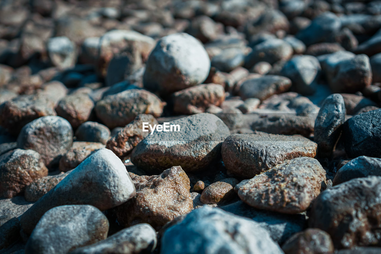Full frame shot of wet pebbles on a beach