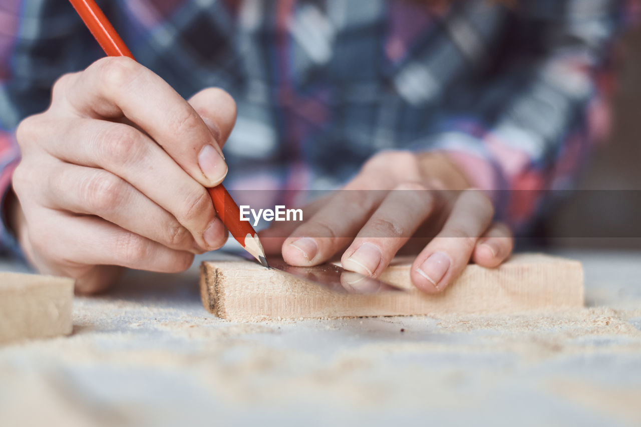 Midsection of carpenter working in workshop