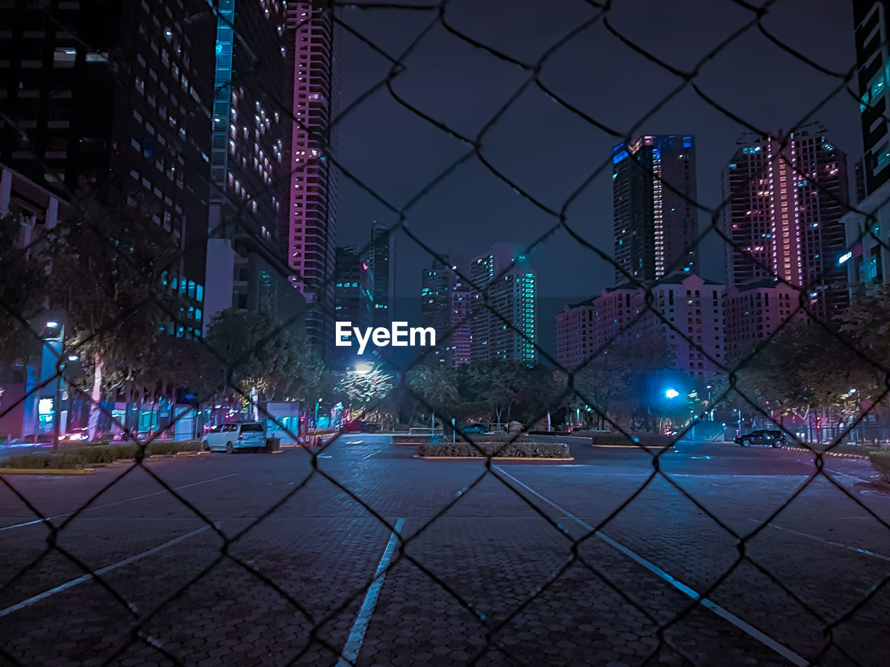 ILLUMINATED BUILDINGS AGAINST SKY AT NIGHT