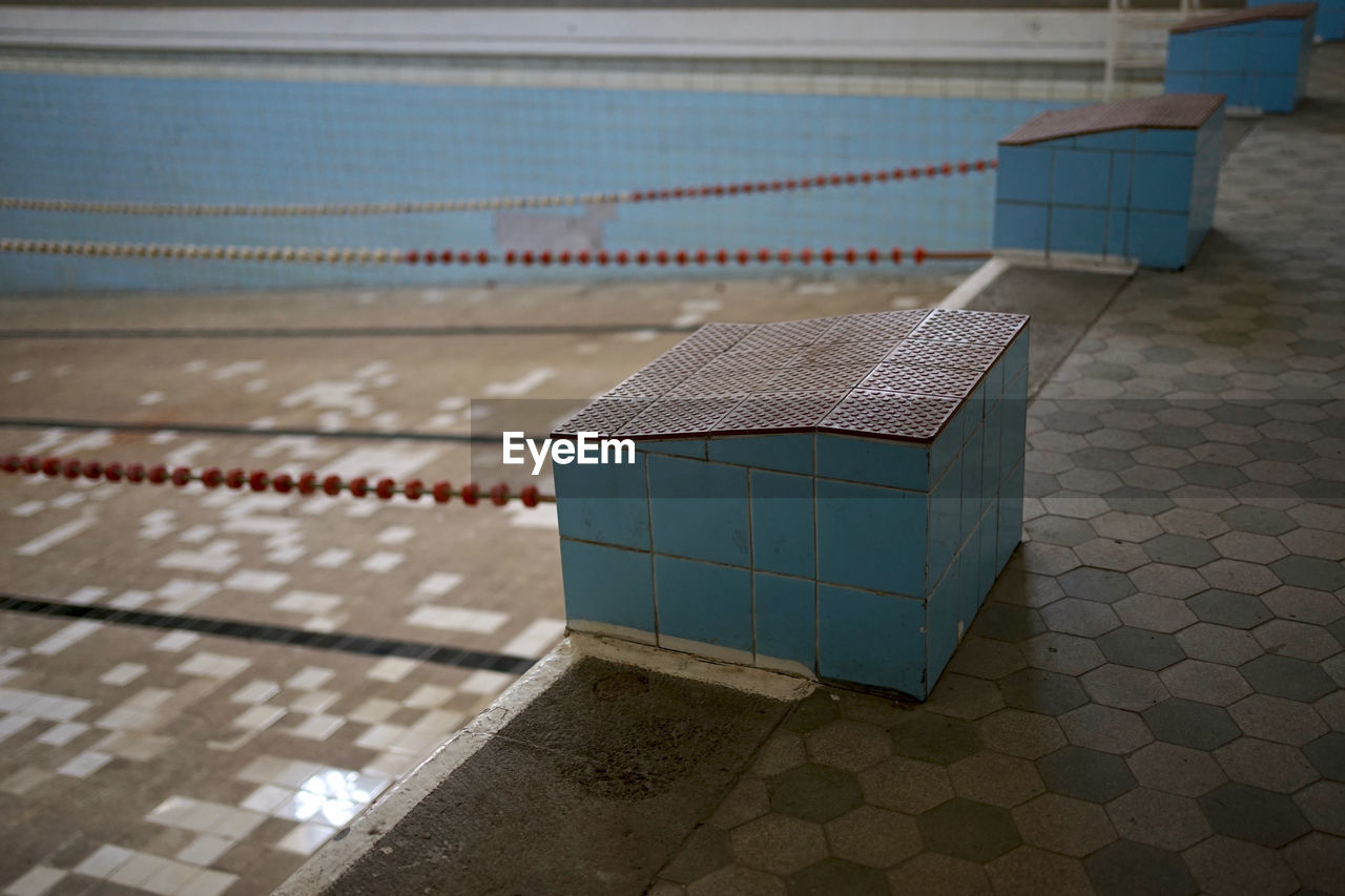 Light blue tiled starting block in abandoned imperial times swimming bath