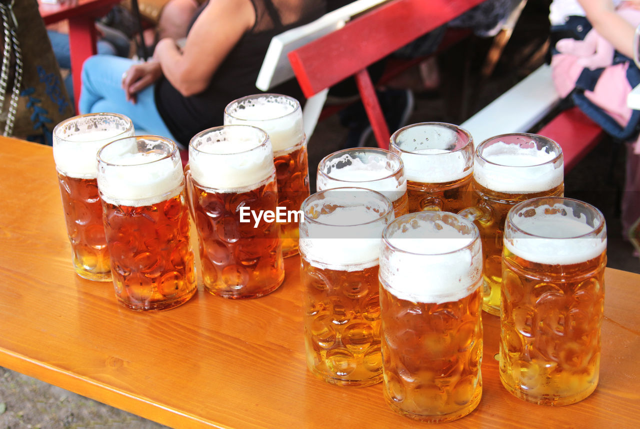 CLOSE-UP OF BEER GLASSES ON TABLE