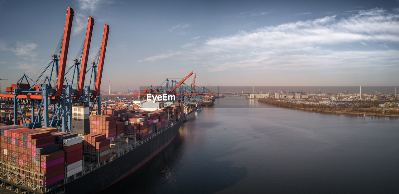 Panoramic view of commercial dock against sky
