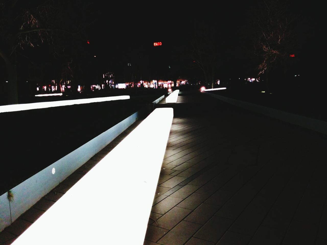 Illuminated walkway at night