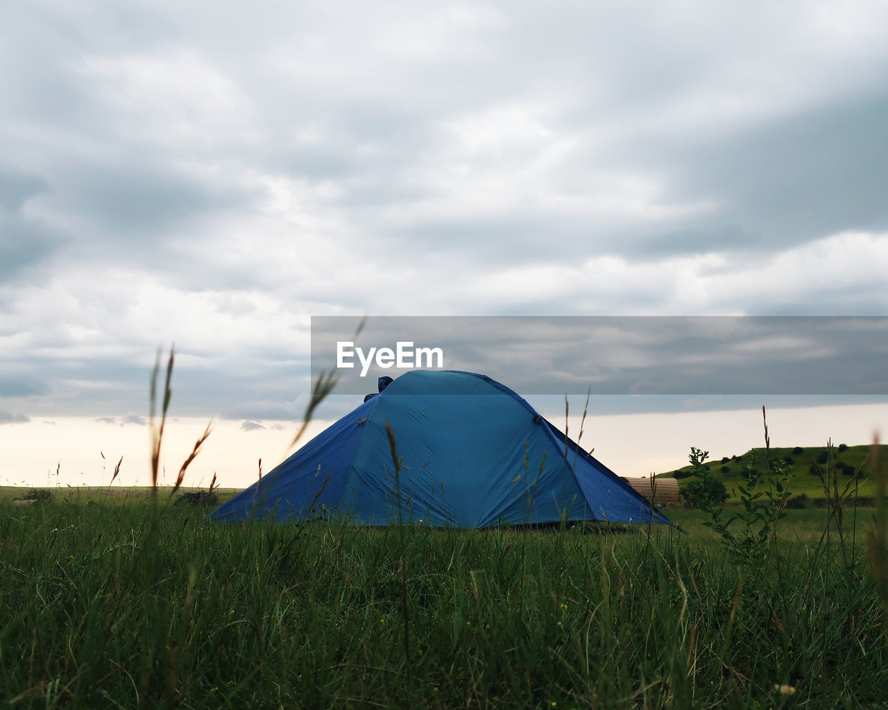 TENT IN FIELD AGAINST SKY
