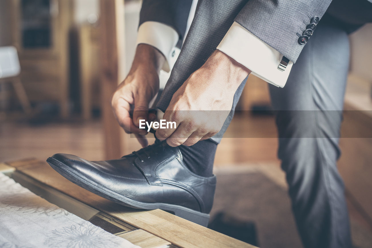 Low Section Of Man Tying Shoes Id 111111630