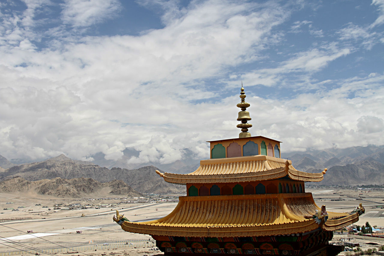 Temple building against cloudy sky
