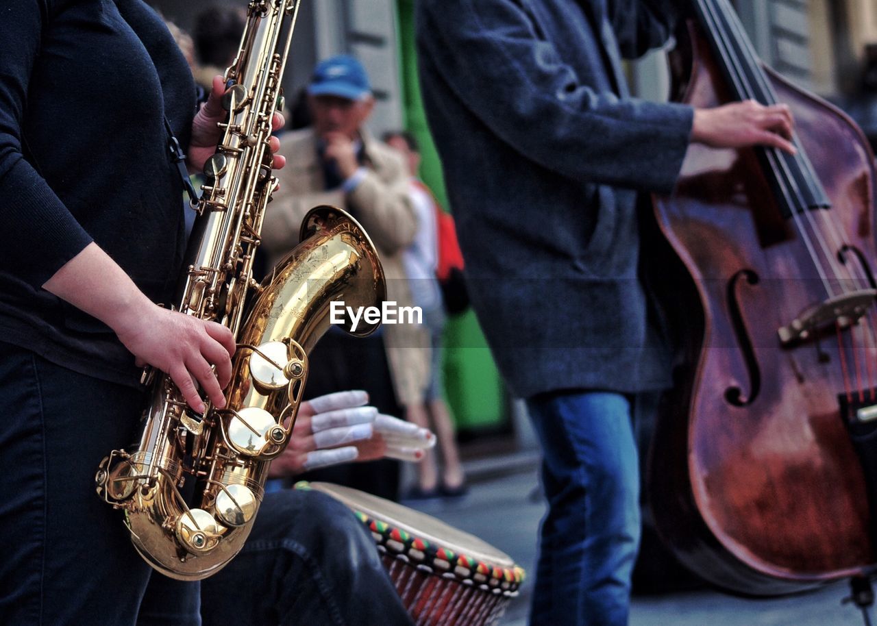 Midsection of musicians performing on street