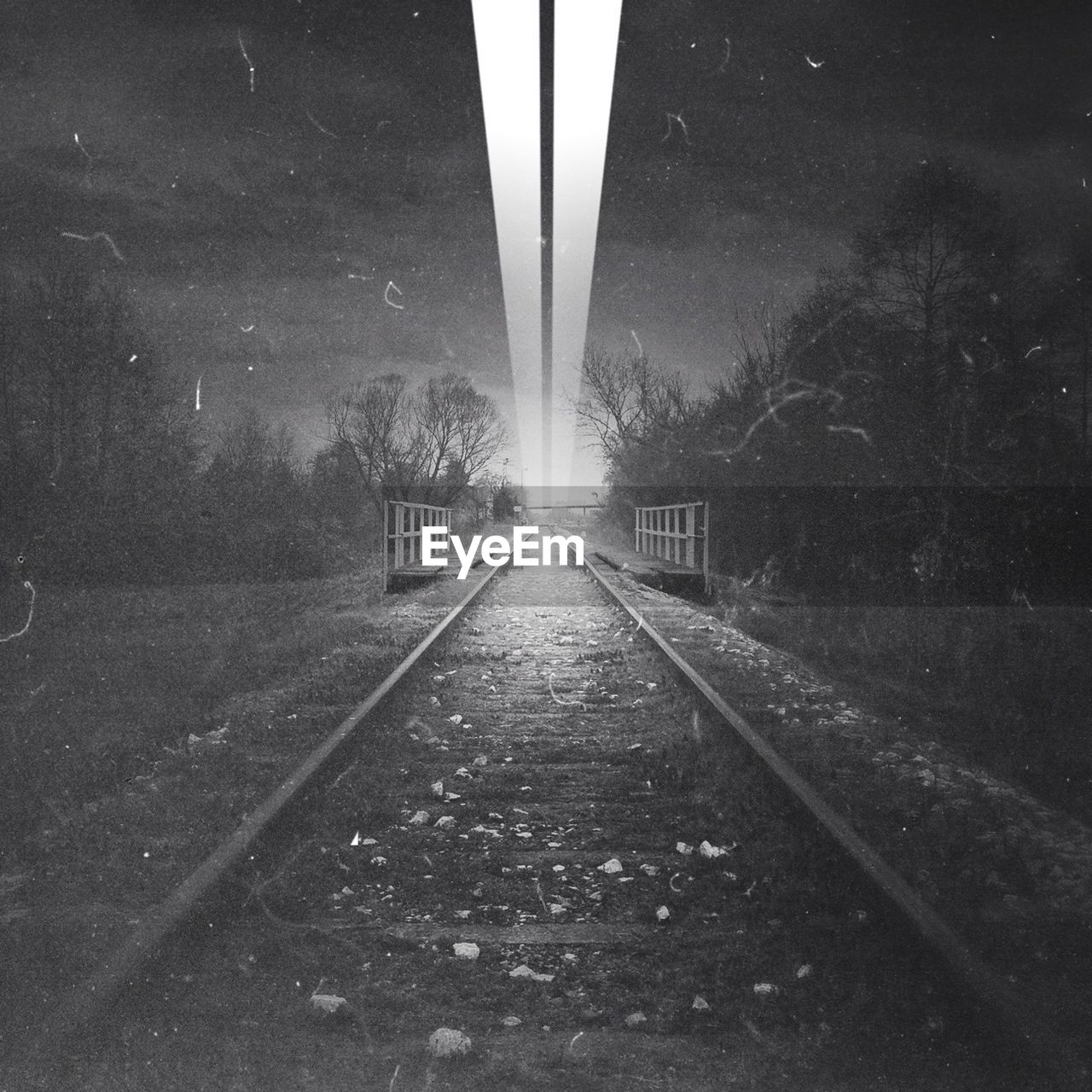 Light beam above railroad track at night