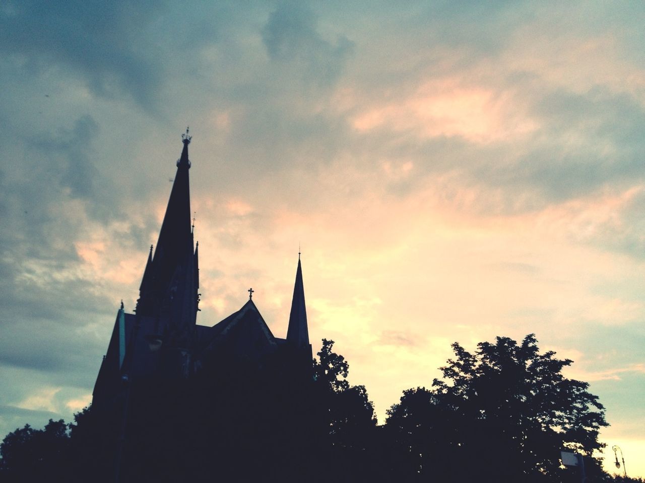 LOW ANGLE VIEW OF CHURCH AGAINST SKY AT SUNSET