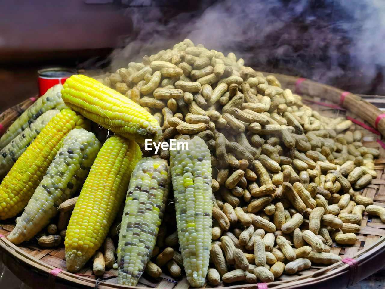 Steaming hot peanuts and corn on a market stall in yangon, myanmar.