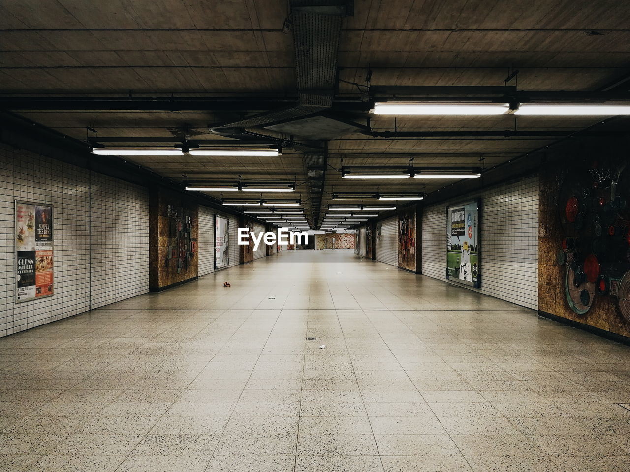 Empty illuminated subway tunnel