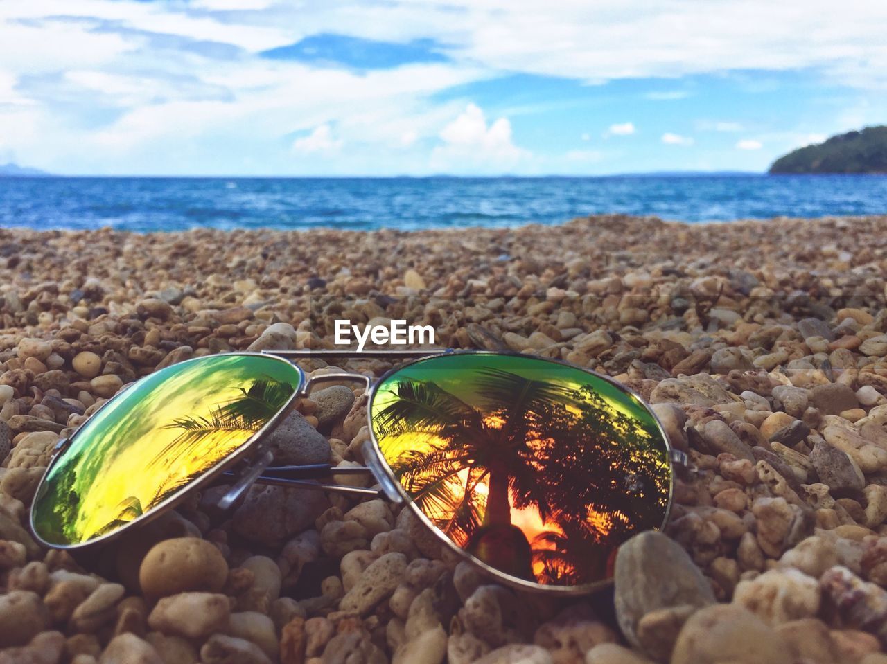 Sunglasses on pebble beach