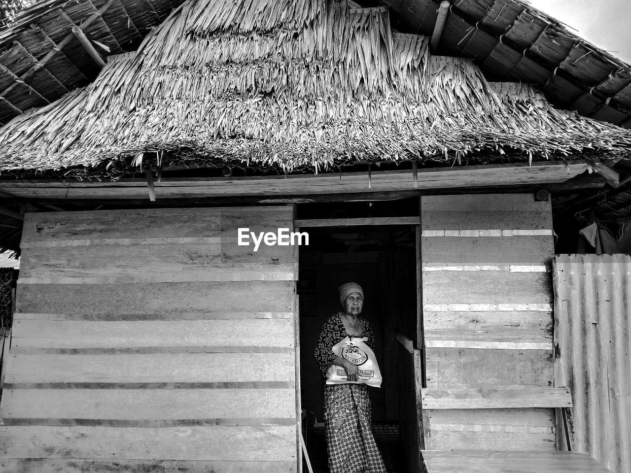 Senior woman standing in hut